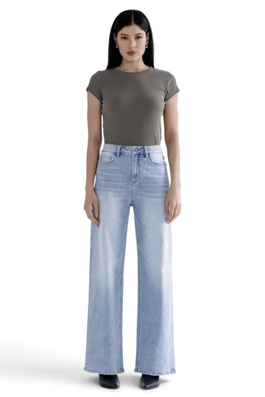 SaltTree Mica Denim super high rise light blue loose straight jeans with whiskering on a model wearing a grey top.
