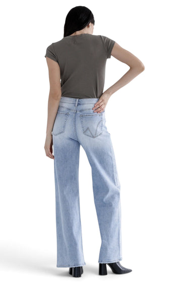 SaltTree Mica Denim light blue super high rise loose straight jeans worn by a model with a grey t-shirt and heels