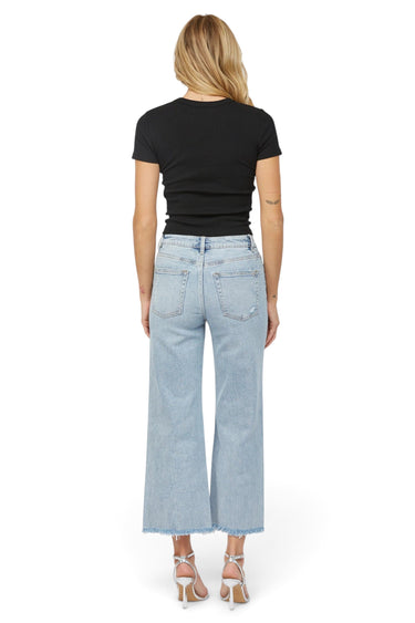 SaltTree Mica Denim high rise wide leg jeans in icy light blue with a raw hem, back view on a model.