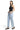 Model wearing SaltTree Mica Denim light wash super high rise barrel leg jeans with curved seams and a raw hem.