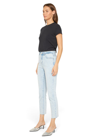 SaltTree model wearing Mica Denim light wash super high rise skinny jeans with a raw hem and black t-shirt