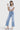 Model wearing SaltTree Mica Denim light wash super high rise wide leg cropped jeans with a white t-shirt.