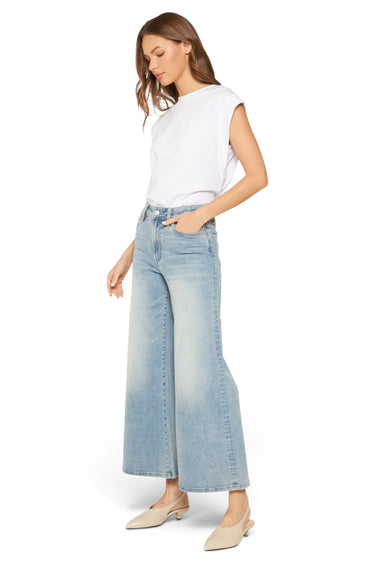 Model wearing SaltTree Mica Denim high rise super wide palazzo crop jeans in a medium wash with a white t-shirt.