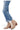 SaltTree Mica Denim medium blue crop flare jeans featuring a frayed shark bite hem worn with tan suede booties.