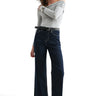 SaltTree model wearing Mica Denim dark indigo high-rise wide-leg ankle jeans with shimmer finish and raw-cut hem.