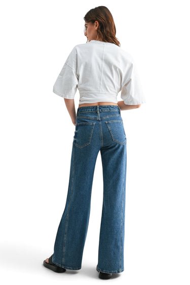 SaltTree Mica Denim high-rise wide-leg jeans in dark indigo with side panel detailing, worn by a model from behind.