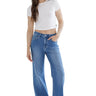 Model wearing SaltTree Mica Denim high-rise wide-leg jeans in medium blue indigo with a white crop top