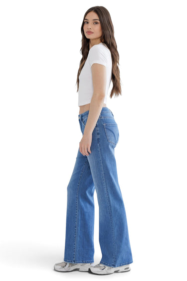 SaltTree model wearing Mica Denim high-rise wide-leg jeans in medium indigo blue with a white crop top