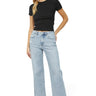 SaltTree model wearing Mica Denim high-rise wide-leg jeans in icy light blue wash with a raw hem and distressed detail