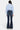 SaltTree Mid Rise Flare Petite Jeans in dark wash denim with whiskering and fading. Features contrast stitching and a 31.75" inseam.