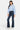 SaltTree Mid Rise Flare Petite Jeans in dark wash denim with whiskering and fading. Features a 31.75" inseam and contrast stitching.