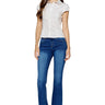SaltTree model wearing ONE HUNDRED B high rise bootcut jeans in medium stone wash denim with a 32-inch inseam