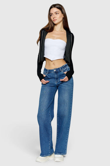 SaltTree model wearing ONE HUNDRED B high rise relaxed wide leg jeans in medium denim wash with whiskering.