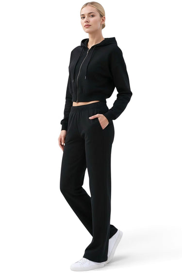 SaltTree model wearing a black Reflex scuba knit cropped zip-up hoodie and matching black lounge pants.