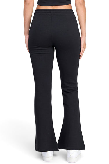 Model wearing SaltTree Reflex black fleece flared joggers with an elasticized waist, viewed from the back.
