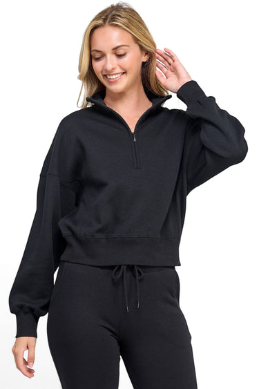 SaltTree Reflex black fleece half-zip sweatshirt with a mock neckline worn by a smiling model in a relaxed fit