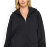 SaltTree model wearing a black Reflex fleece relaxed fit zip-up hoodie with a drawstring hood and kangaroo pockets.