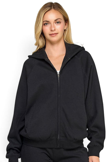 SaltTree model wearing a black Reflex fleece relaxed fit zip-up hoodie with a drawstring hood and kangaroo pockets.