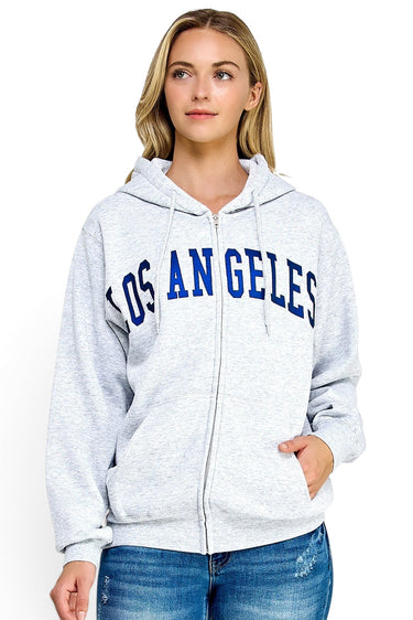 SaltTree model wearing a grey oversized Reflex fleece zip-up hoodie with blue Los Angeles varsity print