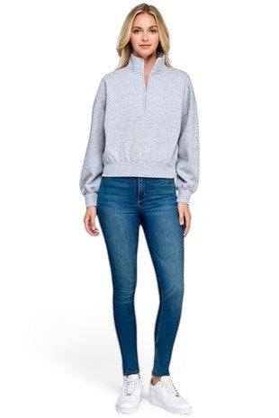 SaltTree model wearing a heather grey Reflex fleece half-zip sweatshirt with a mock neck and relaxed fit with jeans