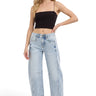 SaltTree model wearing Risen Jeans high-rise light wash barrel denim with cuffed hems and curved side seams.
