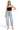 SaltTree model wearing Risen Jeans high-rise light wash barrel denim with cuffed hems and curved side seams.