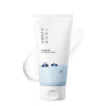 SaltTree Round Lab 1025 Dokdo Cleanser in a white squeeze tube with a blue sea illustration and creamy texture swatch.