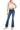 SaltTree model wearing Wax Jean low-rise medium blue bootcut jeans with a comfort-stretch potassium wash finish.
