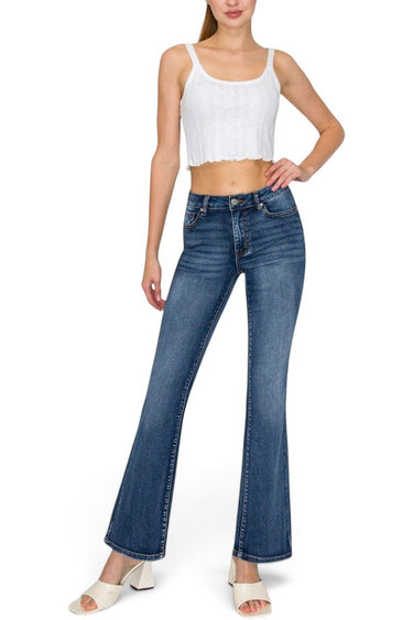 SaltTree model wearing Wax Jean low-rise medium blue bootcut jeans with a comfort-stretch potassium wash finish.