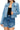 SaltTree Wax Jean medium blue destructed denim trucker jacket with button front and cropped fit on a model