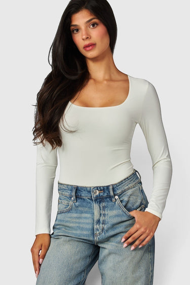 SaltTree model wearing a white Love Poem long sleeve scoop neck bodysuit with a supportive double-layer fit