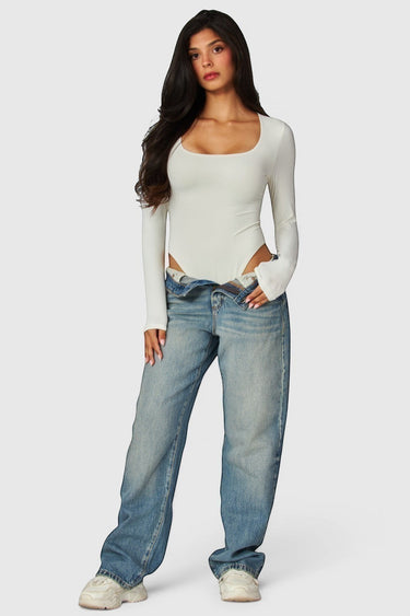 SaltTree model wearing a white Love Poem long sleeve scoop neck bodysuit with blue denim jeans