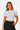 Model wearing a white SaltTree Love Poem seamless crew-neck crop top with cap sleeves against a plain background